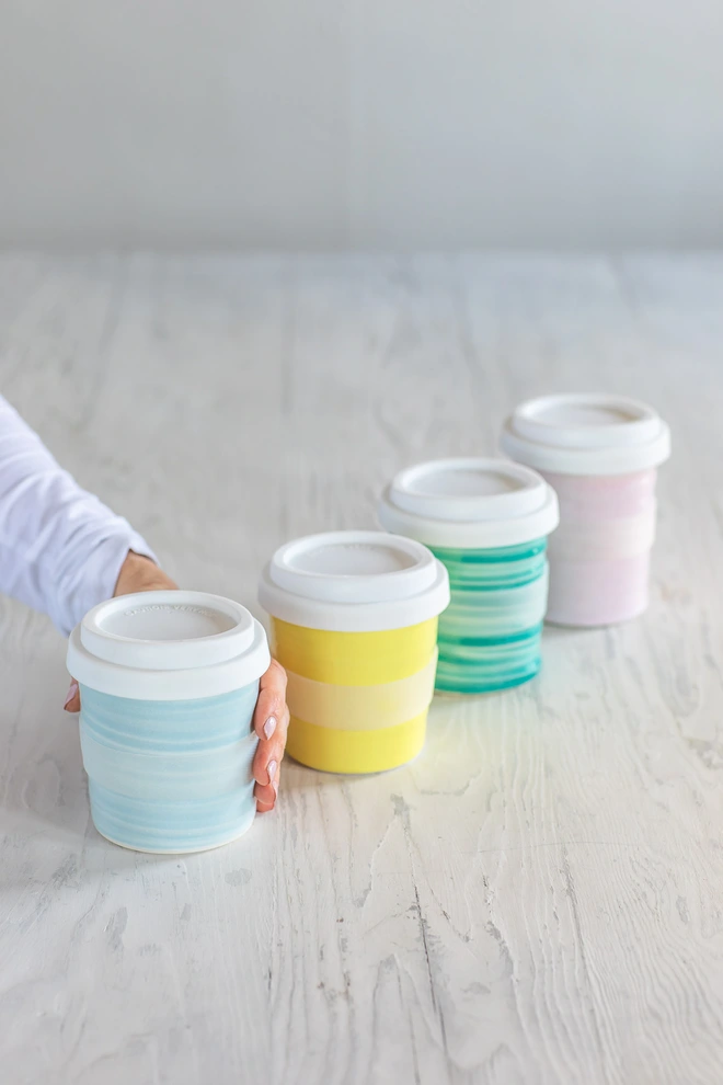 Turquoise, yellow, green and pink travel cups