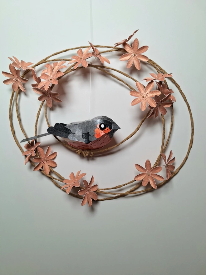 floral wreath wall art featuring a handmade bird sculpture of a bullfinch