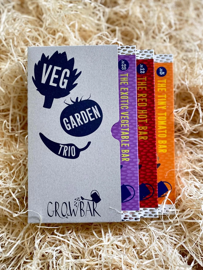 The Veg garden trio kit containing all you need to grow tomatoes, chillies and exotic vegetables nestled on a bed of straw. 
