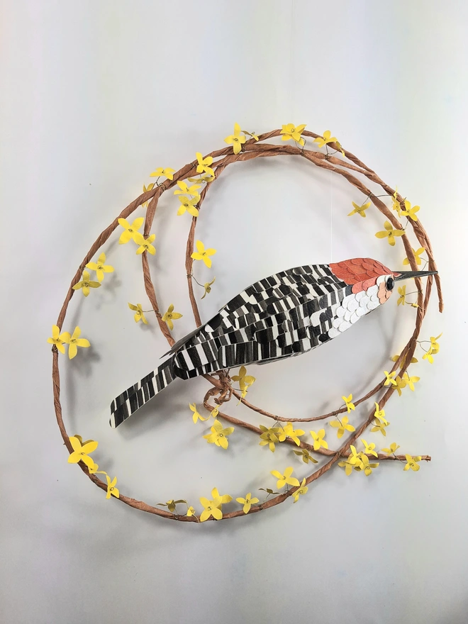 back view of a handmade woodpecker bird sculpture