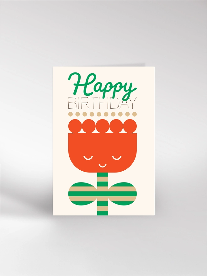 Greeting card with big red illustrated tulip and saying Happy Birthday