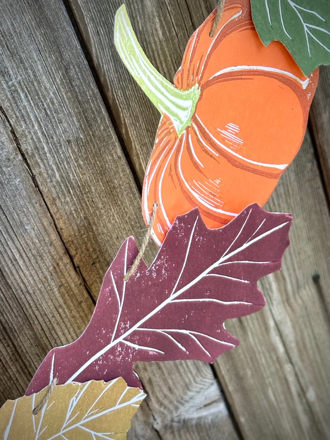 Hand Printed Linocut Pumpkin with oak leaves on a bunting string. Movable components, each one printed individually.