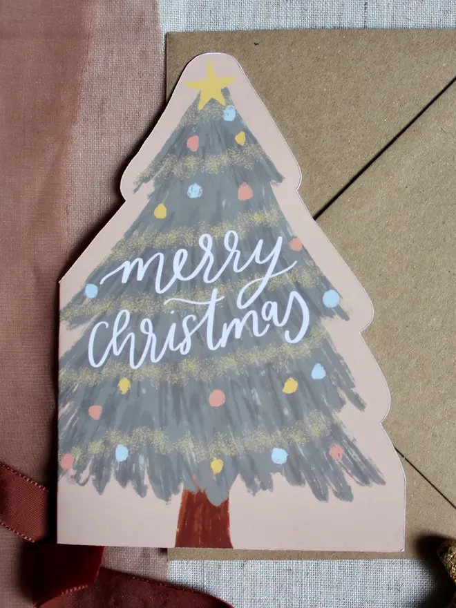 illustrated christmas tree card. illustrated christmas tree made into a card emblazoned with 'merry christmas'. 
