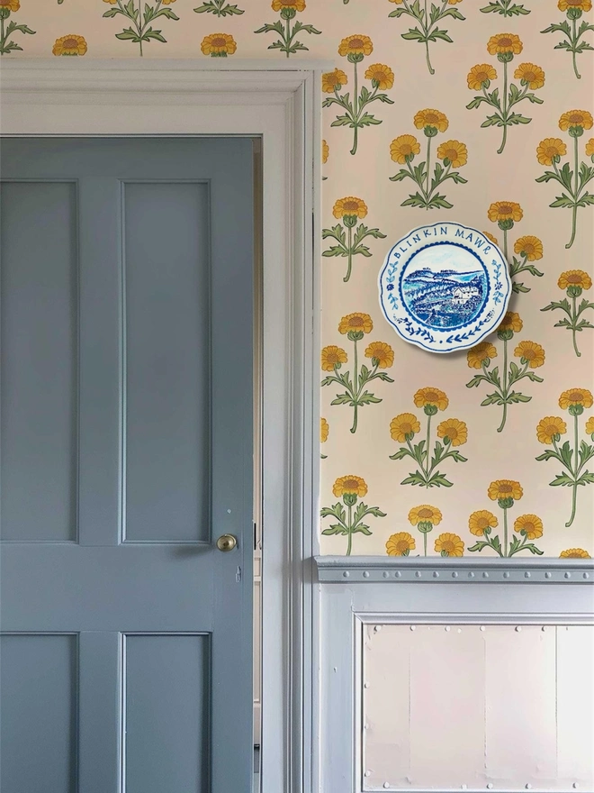 Blue and White hand-painted plate by Circle of Willis hangs on a beautiful interior wall.