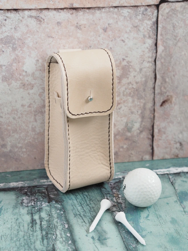 Handmade leather golf ball and tee carry case. A cream coloured leather sleeve for golf accessories