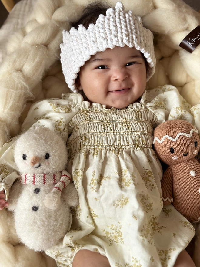 a smiling baby girl christmas style