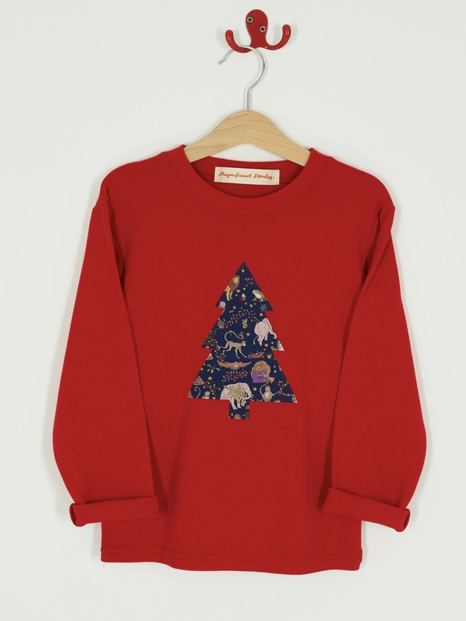  a red t-shirt with a christmas tree cut from Liberty Christmas print sewn onto the front