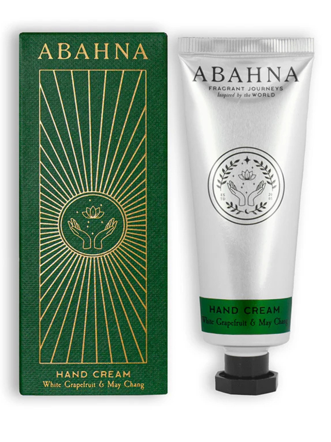 white grapefruit and may chang botanical hand cream. a green box and silver tube containing hand lotion.