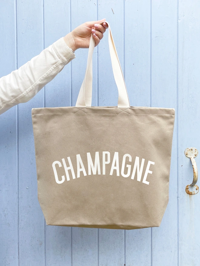 'Champagne' Tote Bag being held up