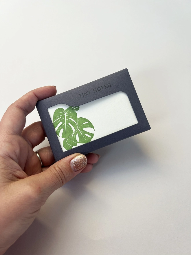 Letterpress green Monstera tiny notes box in a woman's hand to show scale