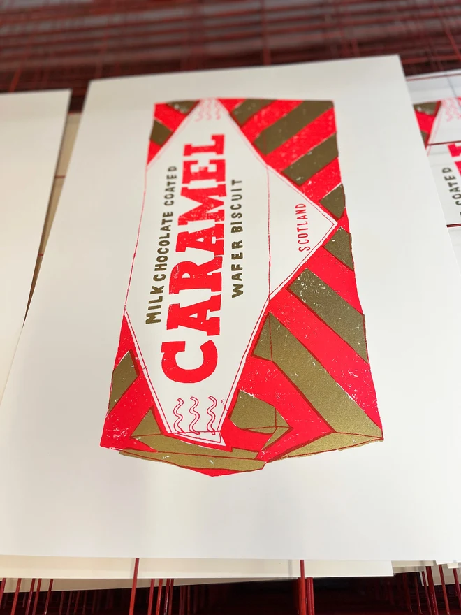 Tunnocks Caramel Biscuit Screenprint Quite Big Caramel, a colourful caramel biscuit screenprint on a studio rack. 