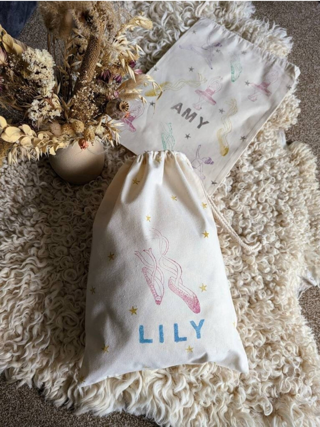 personalised ballet bag. a drawstring ballet bag with a personalised name and printed ballet shoes.