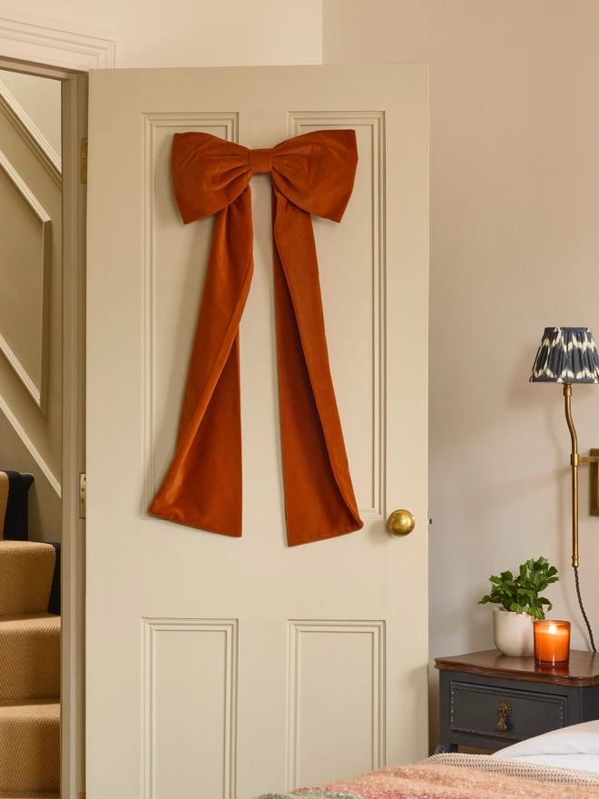 Handmade velvet door bow in warm tones rust coral dusky pink and hot pink, also suitable as Christmas tree topper, Kika Bespoke