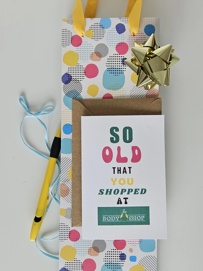 A photograph of the front of a humorous A6 greeting card illustrated using brightly coloured text and the retro shop logo. The text says so old you shopped at The Body Shop