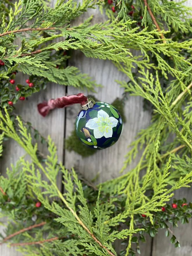 a set of six hand vibrant painted floral ceramic baubles all painted with an array of winter florals each finished with a luxurious velvet ribbon 