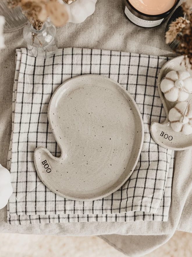 ceramic ghost plate on a monochrome tea towel