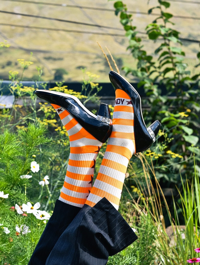 Neon orange breton stripe socks with miu miu pumps