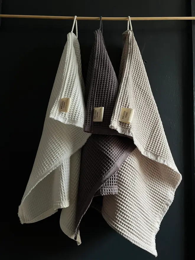 three hanging cotton hand towels