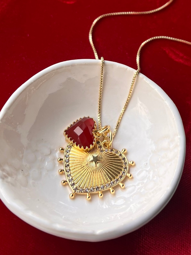 gold vintage style sunburst heart charm necklace with red quartz heart