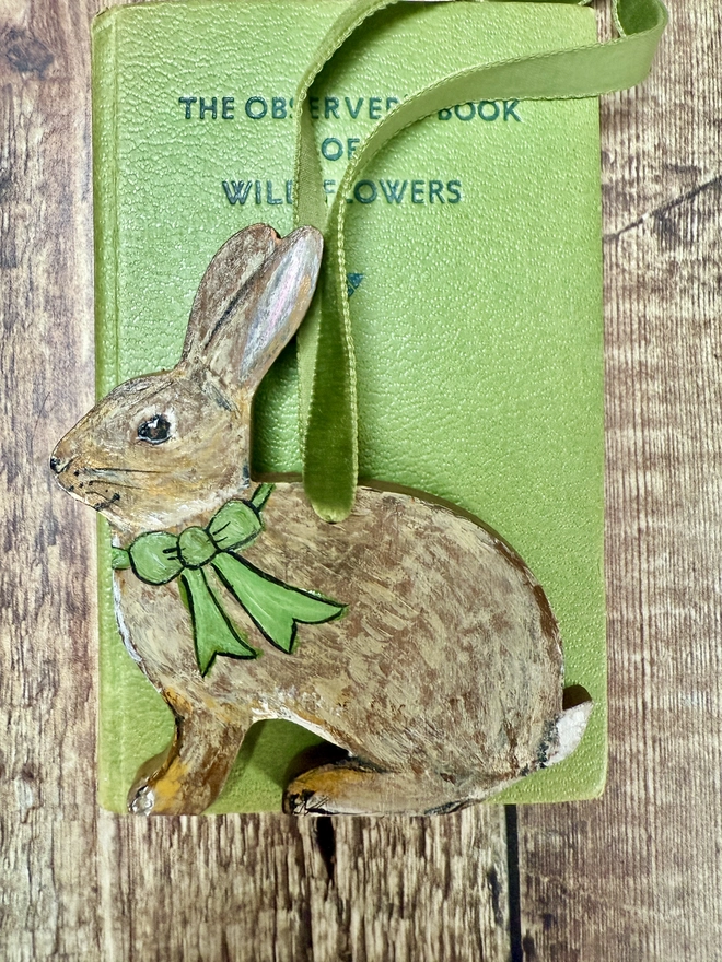 Easter bunny hanging decoration with a green painted bow and green velvet ribbon to hang 