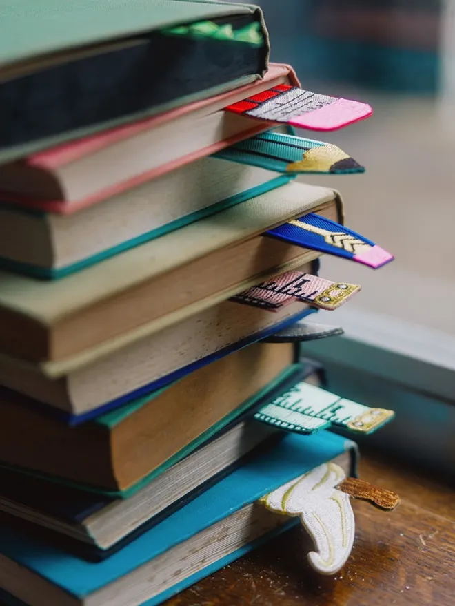 Bookmarks in a pile of vintage hardback books