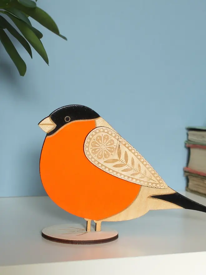 Standing Wooden BullFinch,Standing Wooden BullFinch, orange wooden bird decoration standing on a platform. 