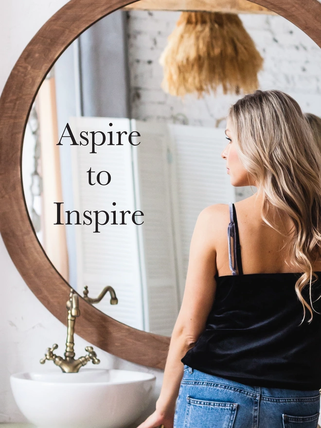 aspire to inspire mirror sticker on a bathroom mirror