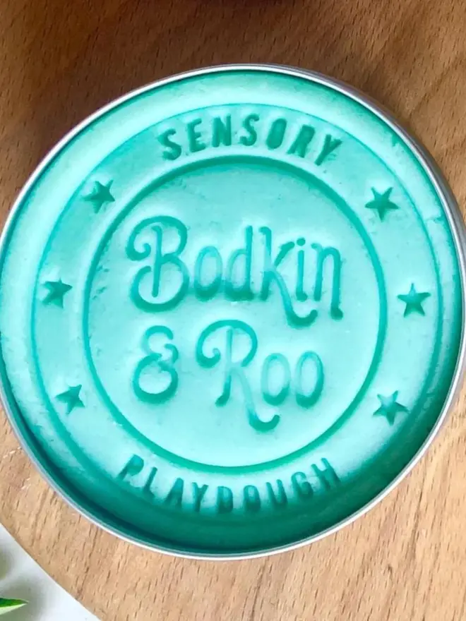 fairy sensory play dough sensory set. a tub of blue play dough.