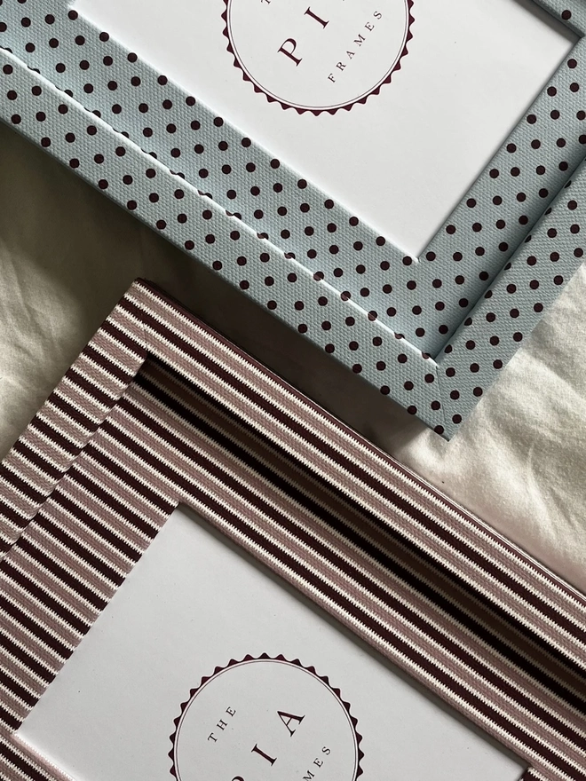 Blush & Burgundy Zigzag Frame, a colourful striped frame sitting on a plain white surface. It is joined by another frame. 