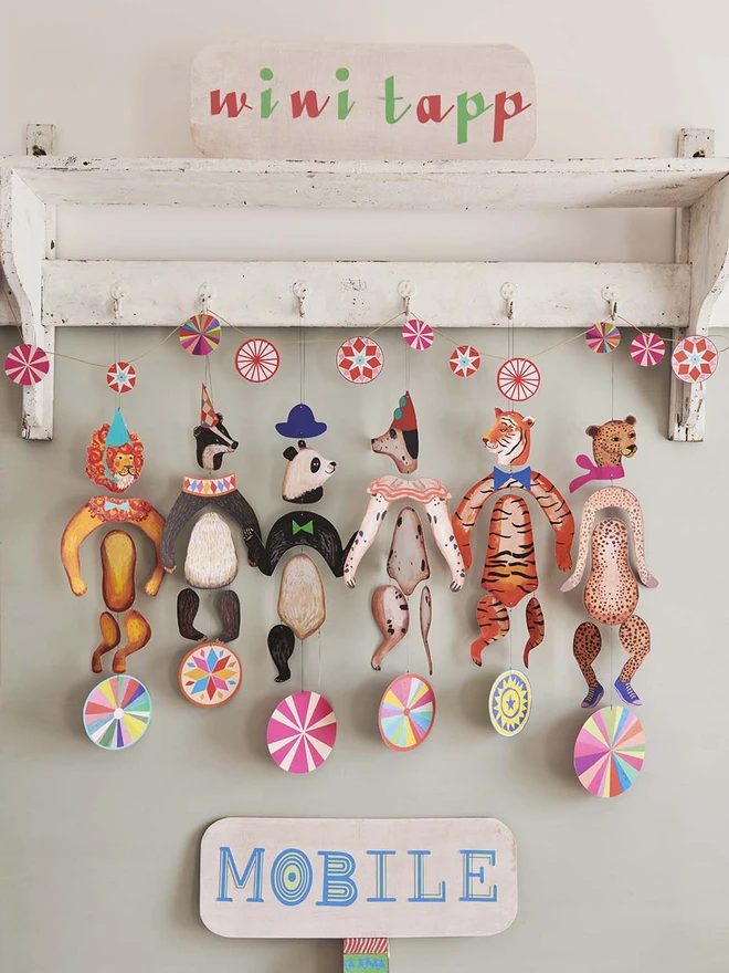 Lion , badger, panda, dog, tiger and cheetah mobiles hanging together
