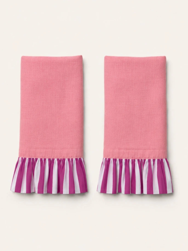 Pair of Ruffle Napkins. A pair of napkins, folded in powder pink and fuchsia.