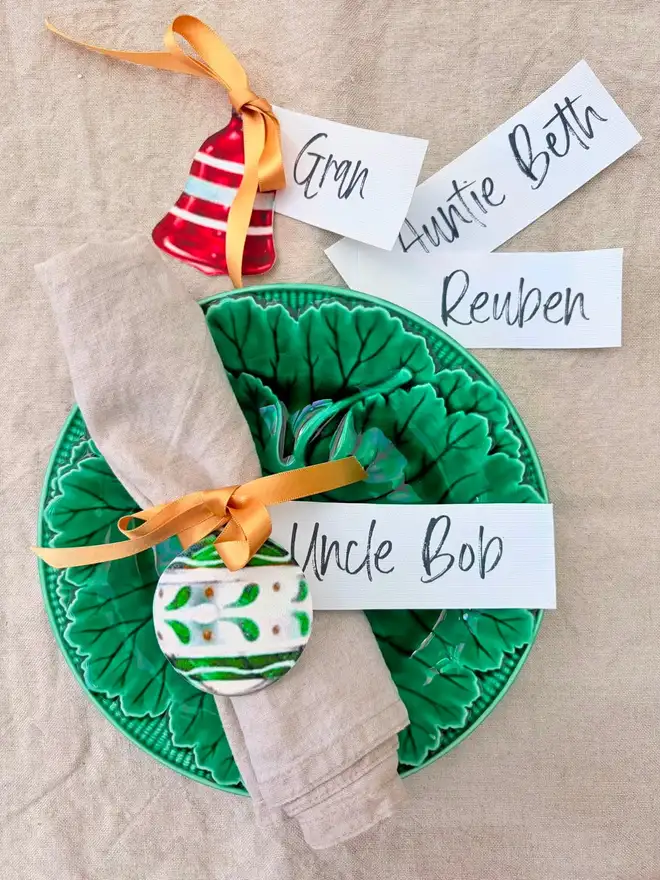 Personalised place settings with fabric cutouts of vintage baubles on a cabbageware plate