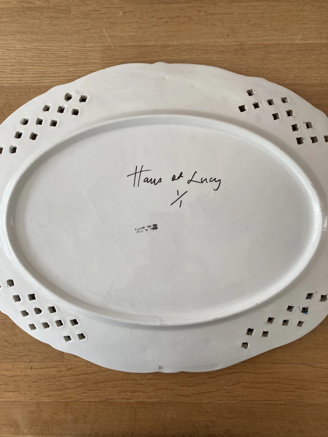 Back of the Lambrini plate showing the Haus of Lucy signature and 1/1 edition.