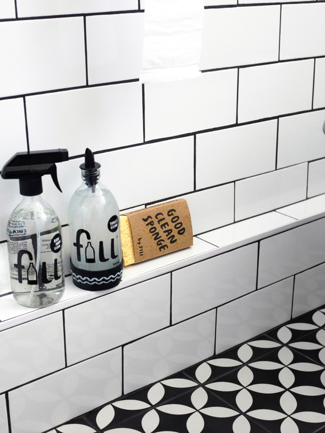 Toilet Cleaner. Bottles of Fill Refill spray in a bathroom.