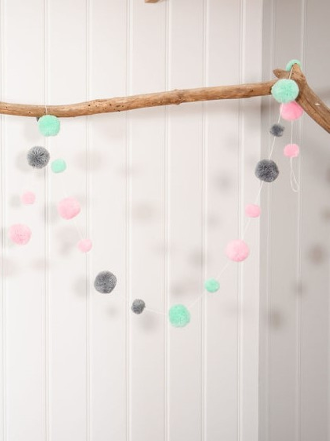 pom pom garland with pastel mint pink and grey pom poms 