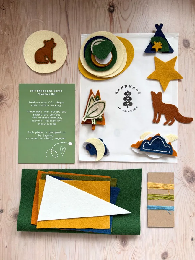 Adventure Felt shapes and scraps kit laid out with an instruction card on a wooden background