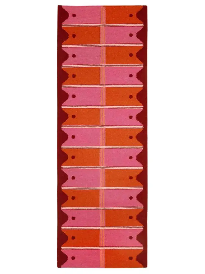 Ladder Flatweave Runner Rug, a colourful rug sitting on a white surface. 