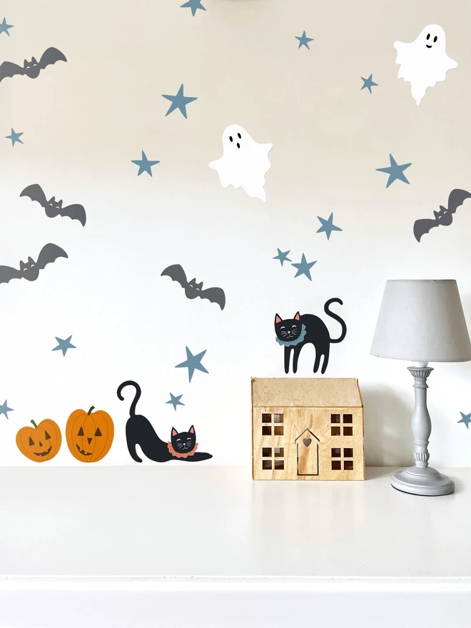 Halloween wall stickers above table with lamp and wooden toy house