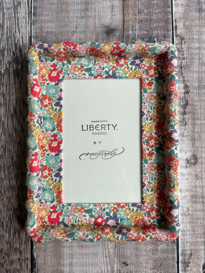 Liberty fabric covered wavy photo frame on backdrop