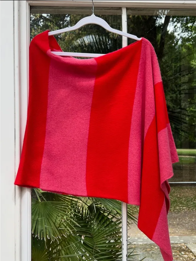 Red pink poncho on hanger front view