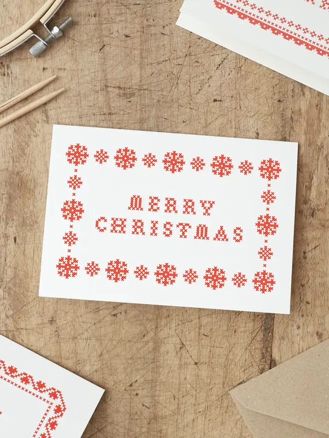 christmas card screen printed with a cross stitch design