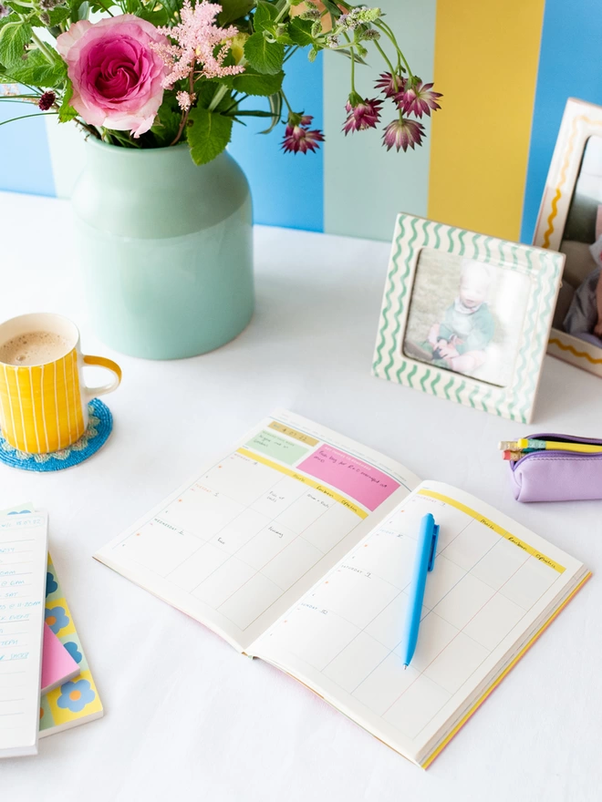 Raspberry Blossom weekly family planner on desk 