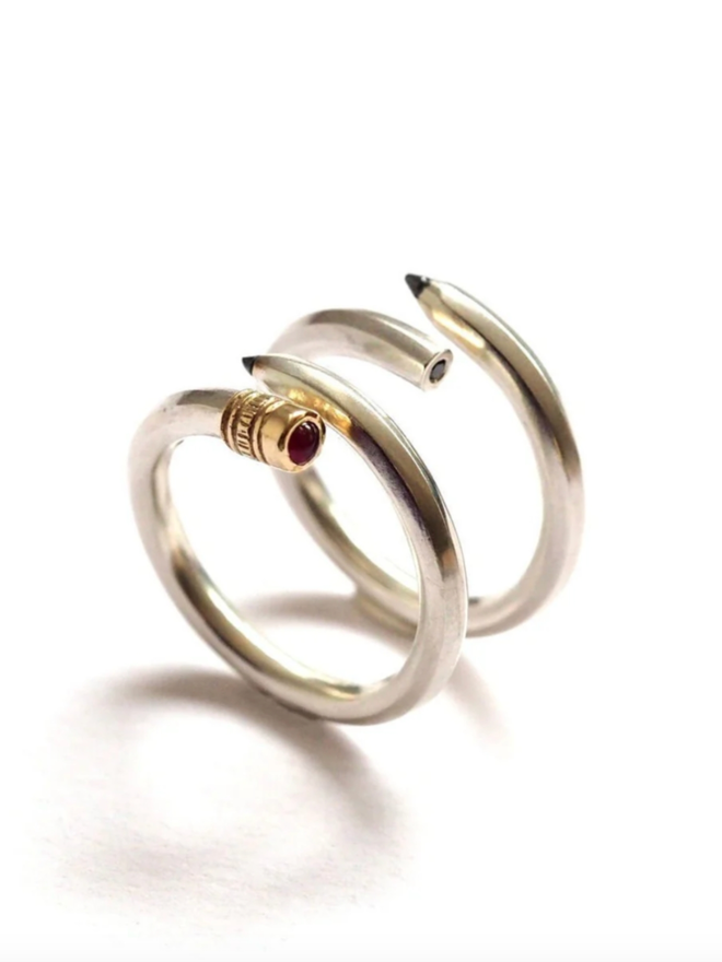 Pencil Ring. Two pencil rings next to each other. One is ruby and the other black diamond.