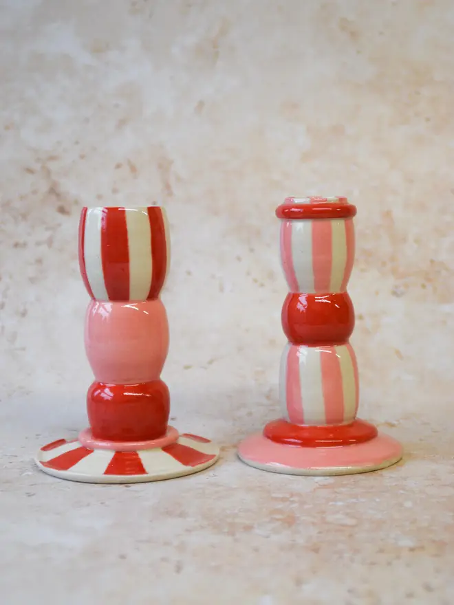 Handmade striped ceramic candlestick holders - close-up of red and pink designs