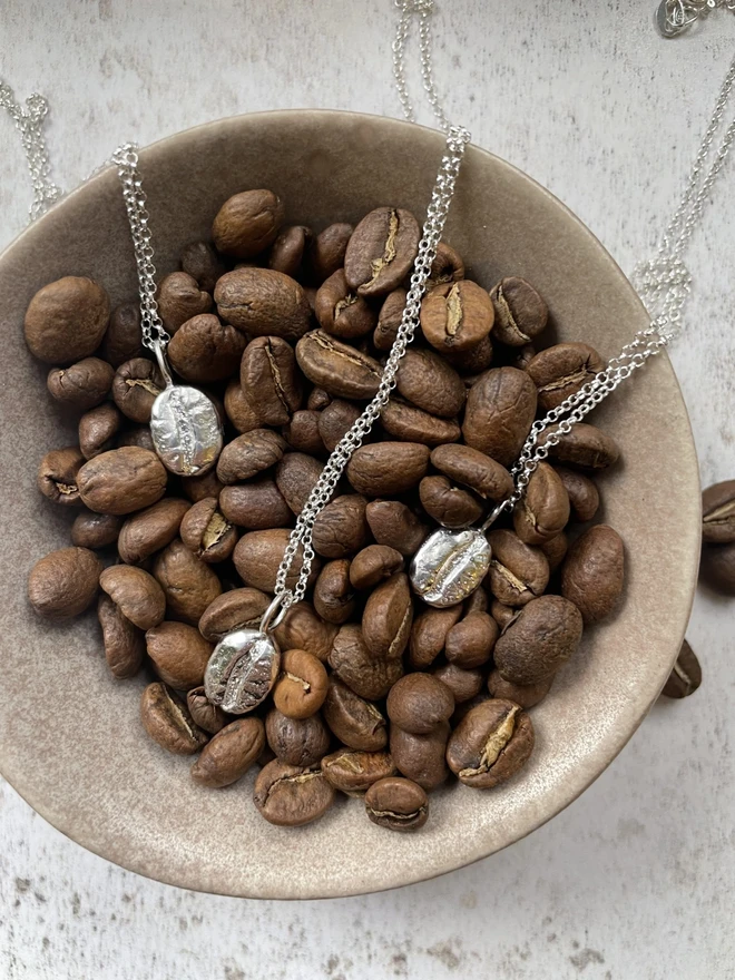 'But First, Coffee' necklace. This brew-tiful little charm pendant is a necessity for the coffee obsessed. This necklace is a tribute to your undying love for the magical elixir of life. The pendant has been sandcast from a real coffee bean using recycled sterling silver. Handmade in my small little studio in Salisbury. 