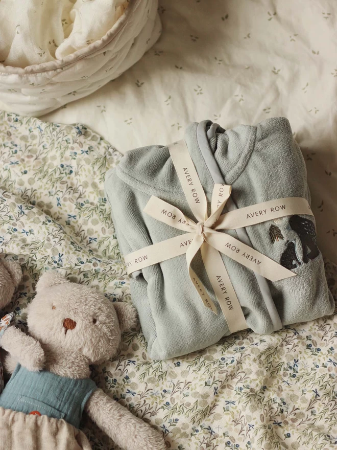 Folded towelling robe for children with a cute bear design
