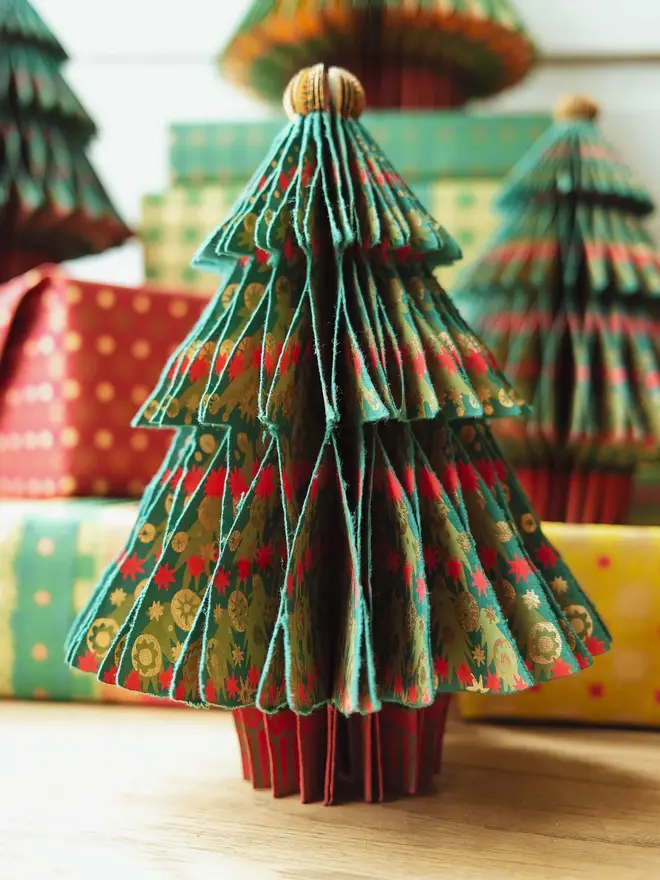 Fir tree honeycomb placed in front of wrapped up presents 