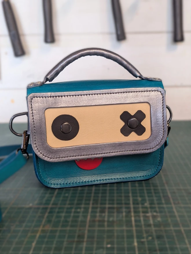 blue leather robot bag, front view