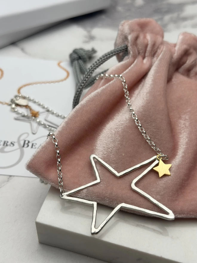 large sterling silver open star charm on sterling silver chain with a mini gold star charm