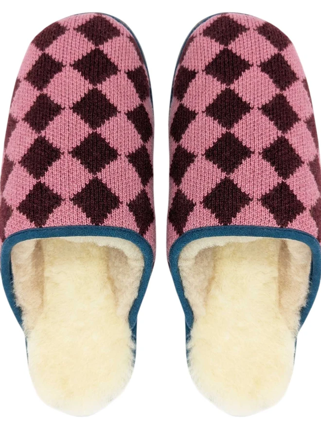 Lambswool & Sheepskin Slippers, a pair of colourful lambswool and sheepskin slippers sitting on a plain white surface. 